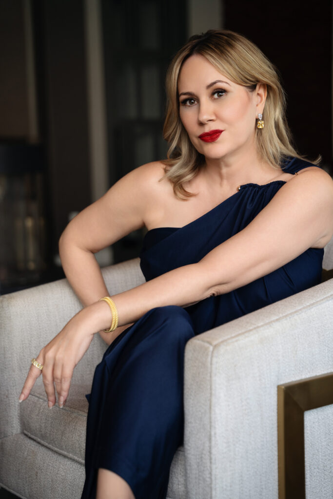 Darla, founder of Emerald Street Designs, seated in a navy blue dress for her personal branding photoshoot in Houston.